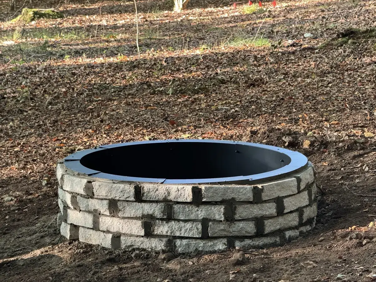 Completed firepit with stone surround and metal liner